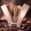 A luxurious product presentation of Risala Forever Eau de Parfum, featuring the 100ml bottle with its signature fountain-pen-nib cap, displayed inside its elegant gift box alongside decorative accents.